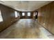 Large room with wood paneling, windows, and a door to the outside at 3415 Spring Valley Blvd, Atlanta, GA 30349