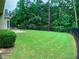Expansive backyard with lush green grass and an iron fence, perfect for outdoor activities at 518 Oriole Farm Trl, Canton, GA 30114