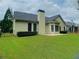 Well-maintained backyard featuring a lush lawn, trimmed shrubs, and a black iron fence at 518 Oriole Farm Trl, Canton, GA 30114