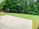 Concrete patio overlooks the well-maintained lawn and fenced backyard providing privacy at 518 Oriole Farm Trl, Canton, GA 30114