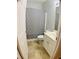 Functional bathroom with a sink, toilet, and shower featuring a patterned curtain at 518 Oriole Farm Trl, Canton, GA 30114