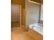 Bathroom with a soaking tub and glass enclosed shower next to the entrance to the Primary bedroom at 518 Oriole Farm Trl, Canton, GA 30114