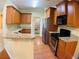 Modern kitchen featuring stainless steel appliances, granite countertops, and wood cabinets at 518 Oriole Farm Trl, Canton, GA 30114