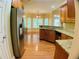 Open kitchen with stainless steel appliances, granite counters, and a view of the dining area at 518 Oriole Farm Trl, Canton, GA 30114