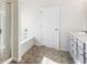 Bathroom featuring a bathtub and shower with glass doors at 1494 Weeping Tree Cir, Auburn, GA 30548