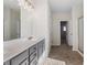 Bathroom with double sinks, gray cabinets, white countertop, and tile floor at 1494 Weeping Tree Cir, Auburn, GA 30548