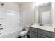 Bathroom showing a white shower/tub combo and gray cabinets with a white countertop at 1494 Weeping Tree Cir, Auburn, GA 30548