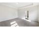 Bright bedroom with recessed lighting, neutral walls and carpet, and doorway to bathroom at 1494 Weeping Tree Cir, Auburn, GA 30548