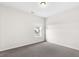 A bedroom offers neutral walls, gray carpet and a window for natural light at 1494 Weeping Tree Cir, Auburn, GA 30548