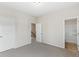Bedroom with neutral walls, gray carpet, and access to the bathroom and hallway at 1494 Weeping Tree Cir, Auburn, GA 30548