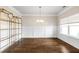 Large dining room with hardwood floors and classic wainscoting providing the perfect canvas for creating your custom entertainment space at 1494 Weeping Tree Cir, Auburn, GA 30548