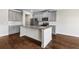 A kitchen featuring gray cabinets, stainless steel appliances and a large island with stone countertops at 1494 Weeping Tree Cir, Auburn, GA 30548