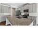 Kitchen area showing the island with a gray countertop, stainless appliances and gray cabinets at 1494 Weeping Tree Cir, Auburn, GA 30548
