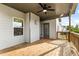 Covered porch with wood decking, a ceiling fan, and views of the surrounding yard at 1494 Weeping Tree Cir, Auburn, GA 30548