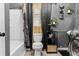 Well-lit bathroom featuring gray walls, a toilet, and hexagon wall decor at 5143 3Rd St, Morrow, GA 30260