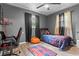 Comfortable bedroom featuring gray walls, a ceiling fan, and a relaxing atmosphere at 5143 3Rd St, Morrow, GA 30260