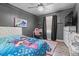 Charming bedroom featuring gray walls, a ceiling fan with light fixture, and stylish decor at 5143 3Rd St, Morrow, GA 30260