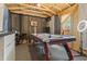 Game room featuring a pool table, bar area, and an open ceiling at 5143 3Rd St, Morrow, GA 30260