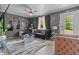 Stylish living room with modern decor, unique art, sleek furnishings, and large windows offering ample natural light at 5143 3Rd St, Morrow, GA 30260