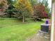 A lush backyard with trees and a patio in the foreground at 7123 Woodridge Ln, Union City, GA 30291
