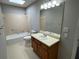 Bright bathroom featuring a shower and tub combo with a vanity and light fixtures above the mirror at 7123 Woodridge Ln, Union City, GA 30291