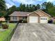 Charming single-story home with a two-car garage and a well-maintained front yard and long concrete driveway at 7123 Woodridge Ln, Union City, GA 30291