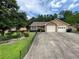 Charming single-story home with a wide driveway and two-car garage at 7123 Woodridge Ln, Union City, GA 30291