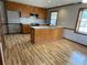 Cozy kitchen featuring an island, stainless steel dishwasher, ample cabinet space and hardwood floors at 7123 Woodridge Ln, Union City, GA 30291