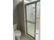 A shower stall with a glass door and white tiled walls at 7123 Woodridge Ln, Union City, GA 30291