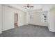 Large bedroom with neutral carpet, tray ceiling, ceiling fan, and natural light at 2035 Stonebrook Dr, Austell, GA 30106