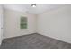 Spacious bedroom with neutral carpet, window, and door at 2035 Stonebrook Dr, Austell, GA 30106