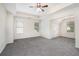 Spacious bedroom with large windows, tray ceiling, ceiling fan, and neutral carpet at 2035 Stonebrook Dr, Austell, GA 30106