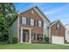 Charming two-story home with brick and siding exterior, dark shutters, and a well-maintained front yard at 2035 Stonebrook Dr, Austell, GA 30106