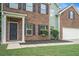 Inviting front entrance with brick facade, dark shutters, and landscaped garden beds at 2035 Stonebrook Dr, Austell, GA 30106