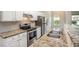 Kitchen with stainless steel appliances, granite countertops, white cabinets, and hardwood floors at 2035 Stonebrook Dr, Austell, GA 30106