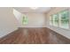Spacious living area with hardwood floors, natural light, and view of staircase at 2035 Stonebrook Dr, Austell, GA 30106