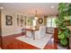 Dining room features hardwood floors, built-in bookshelves, and a view to the home's front entrance at 2997 Happy Hollow Se Dr, Conyers, GA 30094