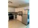 Open kitchen with stainless steel appliances and light tan linoleum flooring at 2997 Happy Hollow Se Dr, Conyers, GA 30094