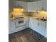 Modern kitchen features white cabinetry, stainless sink, and a modern electric range at 2997 Happy Hollow Se Dr, Conyers, GA 30094