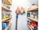 Organized pantry featuring wooden shelves with an array of goods at 2997 Happy Hollow Se Dr, Conyers, GA 30094