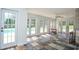 Sunroom with checkerboard tile floors and multiple french doors to the pool area at 2997 Happy Hollow Se Dr, Conyers, GA 30094