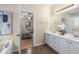Bathroom with double vanity sinks, ceramic tile floors, and a tub in a neutral color palette at 3610 Chestnut Meadows Dr, Douglasville, GA 30135