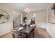 Elegant dining room with a view of the stairs and classic wainscoting details at 3610 Chestnut Meadows Dr, Douglasville, GA 30135