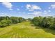 Aerial view of the property showcasing lush trees, large yard, and well-kept grass at 4935 Stablegate Ct, Cumming, GA 30028