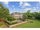 Aerial view of a beautiful estate with a large pool, lush landscaping, and a well-manicured lawn at 4935 Stablegate Ct, Cumming, GA 30028
