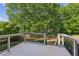 Enjoy the outdoor view from this spacious back deck featuring iron and wood railing overlooking the lush grounds at 4935 Stablegate Ct, Cumming, GA 30028
