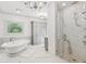 Luxury bathroom featuring a free-standing tub and a glass-enclosed marble shower at 4935 Stablegate Ct, Cumming, GA 30028