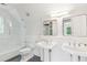 A bathroom with dual vanities, modern fixtures, and glass enclosed shower at 4935 Stablegate Ct, Cumming, GA 30028