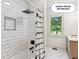 Bathroom includes a tiled shower with a black shower head and a window view at 4935 Stablegate Ct, Cumming, GA 30028