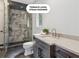 Elegant bathroom featuring a steam shower, marble tile, stylish vanity, and modern fixtures at 4935 Stablegate Ct, Cumming, GA 30028